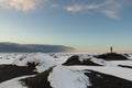 Person watching an approaching storm from a snow covered black s Royalty Free Stock Photo