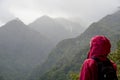 Person watching bad weather in overgrowth mountains, Madeira, Portugal