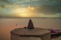 A person is watching beautiful sunrise on the bank of river ganga at ghats of varanasi while meditating Royalty Free Stock Photo