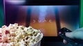 Person watching Dune movie with popcorn and remote control. Stock editorial photo.