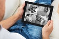 Man Sitting On Sofa And Monitoring Video Footage Royalty Free Stock Photo