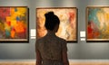 person watching television. Back of an adult woman looking at abstract style p