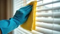Person wearing blue rubber glove cleans white window blinds with yellow microfiber cloth. Home routine activity with household Royalty Free Stock Photo