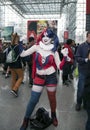 Person wearing Harley Quinn costume with others at NY Comic Con