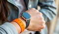 Person wearing modern health tech wristwatch. Person checks time health data on digital device. Focus on wearable health