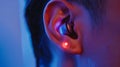 A person wearing a sleek wireless neural implant on their ear blending seamlessly with their skin.