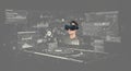 A person wearing a virtual reality headset is surrounded by digital interfaces, including Royalty Free Stock Photo