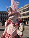 Person wearing a whimsical white rabbit costume during the Carnival of Venice
