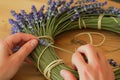 person weaving lavender stems into a fragrant flower wreath Royalty Free Stock Photo