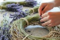 person weaving lavender stems into a fragrant flower wreath Royalty Free Stock Photo