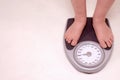 Person on weight scale Royalty Free Stock Photo