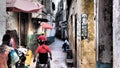 Person in wheelchair moving in narrow streets of Lamu Island