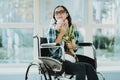 Happy Woman in Wheelchair with Flowers at Airport.