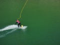 Person who practices wakeboarding and who rides through the water of Orgon lake, nestled in the Alpilles in Provence in France