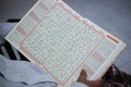 A person who is reading the holy Koran