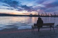 A person who is watching the sunset over the sea station in Varna. Royalty Free Stock Photo