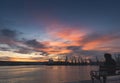 A person who is watching the sunset over the sea station in Varna. Royalty Free Stock Photo