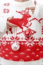 Person in winter sweater holding Christmas balls in hands. Close Royalty Free Stock Photo