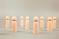 Person wooden doll standing with many wooden dolls. Royalty Free Stock Photo