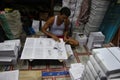 A person is working on binding books.