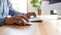 Person Working on Computer at Desk in Natural Light. Royalty Free Stock Photo