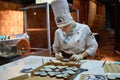 Person working inside of the Lviv Homemade Chocolate Factory.