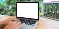 Person working on a laptop computer in a modern room. Woman using laptop with blank white screen on wooden table in modern loft ca Royalty Free Stock Photo