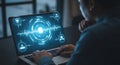 Person working on a laptop with a futuristic interface and data visualization Royalty Free Stock Photo