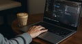 Person Coding on Laptop with Coffee Latte on Table, Creative Work Environment Royalty Free Stock Photo