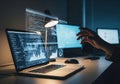 Person working late on a laptop with a glowing overlay of code and data dashboards Royalty Free Stock Photo
