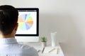 A person working at office with personal computer screen that have a coffee and tillandsia air plant with space for text on white