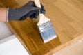 Person working oiling kitchen countertop before using brushing oiling with linseed oil.