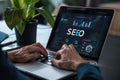 Person working on SEO strategy on a laptop, analyzing data and optimizing website performance in a professional setting