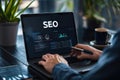 Person working on SEO strategy on a laptop, analyzing data and optimizing website performance in a professional setting