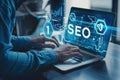 Person working on SEO strategy on a laptop, analyzing data and optimizing website performance in a professional setting