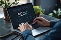 Person working on SEO strategy on a laptop, analyzing data and optimizing website performance in a professional setting