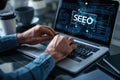 Person working on SEO strategy on a laptop, analyzing data and optimizing website performance in a professional setting