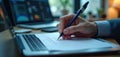 Person works on laptop. Hand with pen fills check list on paper. Person uses tech. Checklist digital project. Person focuses on