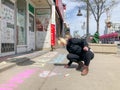 TORONTO, ONTARIO, CANADA - APRIL 28, 2020: PERSON WRITES POSITIVE MESSAGE IN CHALK ON SIDEWALK DURING COVID-19 PANDEMIC.