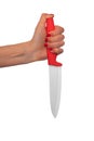 A person& x27;s hand grips a red-handled ceramic knife on a white background. Royalty Free Stock Photo