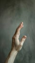 A person& x27;s hand reaching out to catch a ball in the air, AI