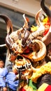 Person in a yellow devil mask at the Diablada