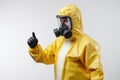 A person in a yellow hazmat suit and gas mask in white background .generative ai Royalty Free Stock Photo