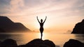 Person in yoga pose on a rocky shore at sunset Royalty Free Stock Photo