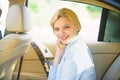 Personal assistant and driver. Business life concept. Business woman sit on backseat. Busy lady passenger leather car