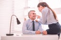 Personal assistant and her boss flirting at the workplace Royalty Free Stock Photo