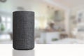 Personal assistant loudspeaker on a white wooden shelf of a smart home living room. Empty copy space Royalty Free Stock Photo