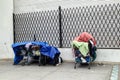 Personal belongings of homeless in shopping carts on sidewalk