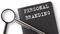 PERSONAL BRANDING- business concept, magnifier with white text message on black notebook Royalty Free Stock Photo