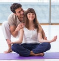 Personal coach helping during yoga session